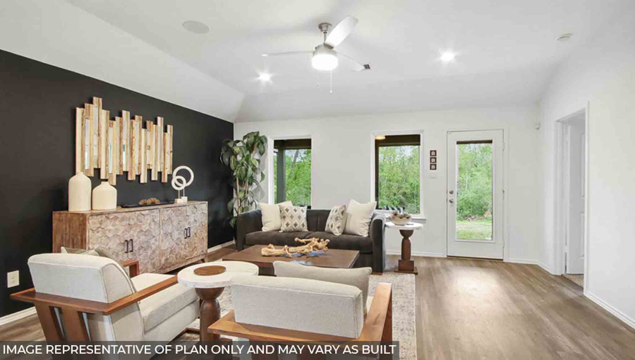 Open concept living and dining area with vinyl flooring and bright windows.