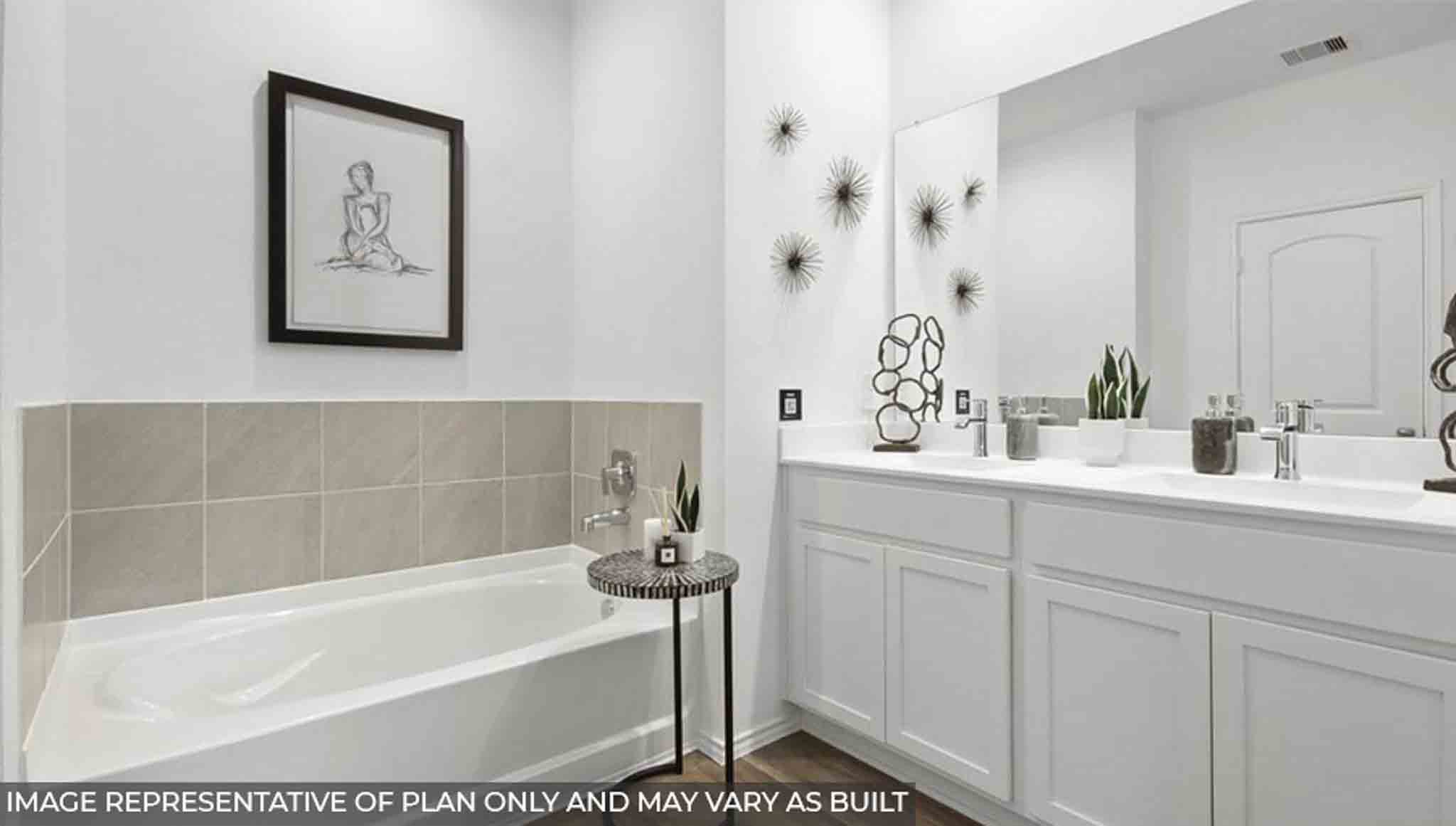 Primary bathroom with vinyl flooring and a tile tub.
