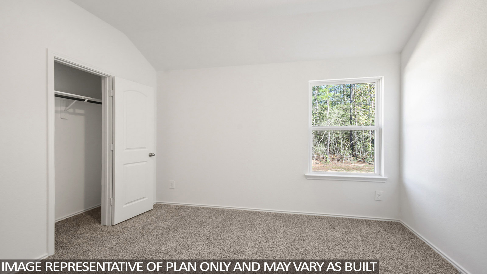 Secondary bedroom with carpet flooring