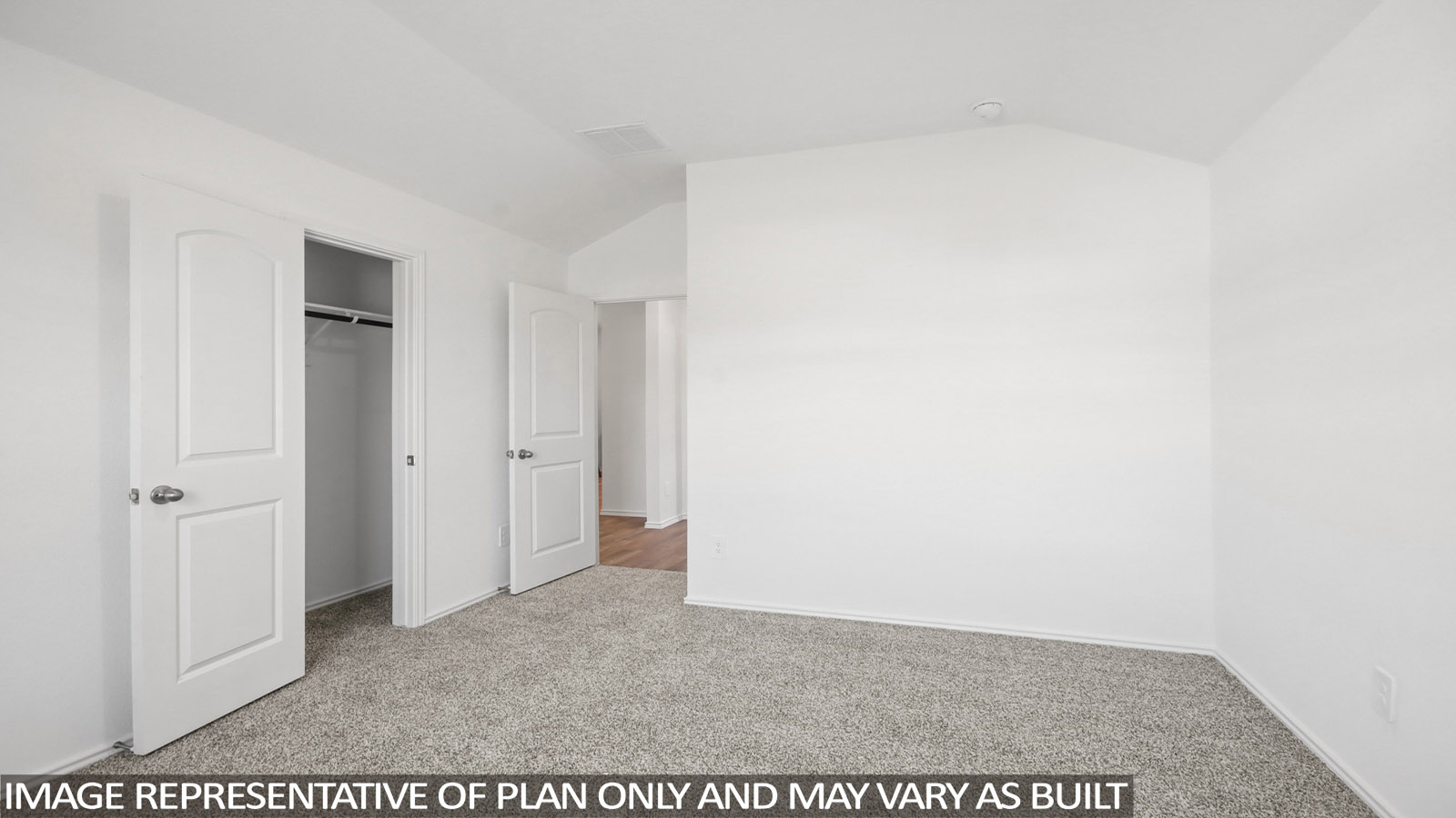 Secondary bedroom with carpet flooring