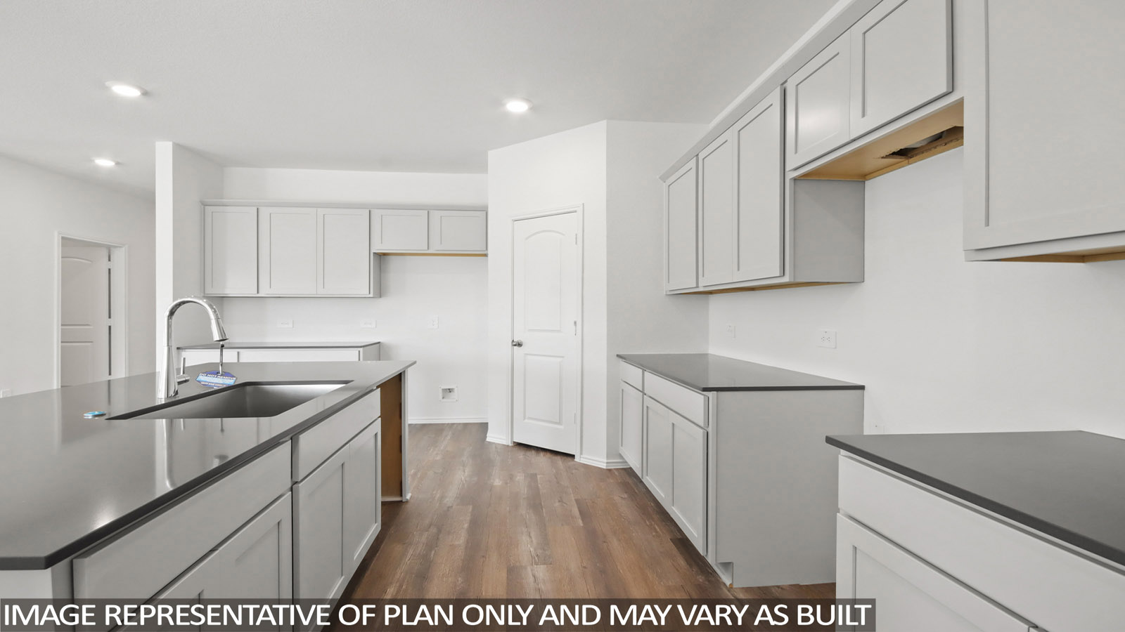 Kitchen with an island and a tall pantry.