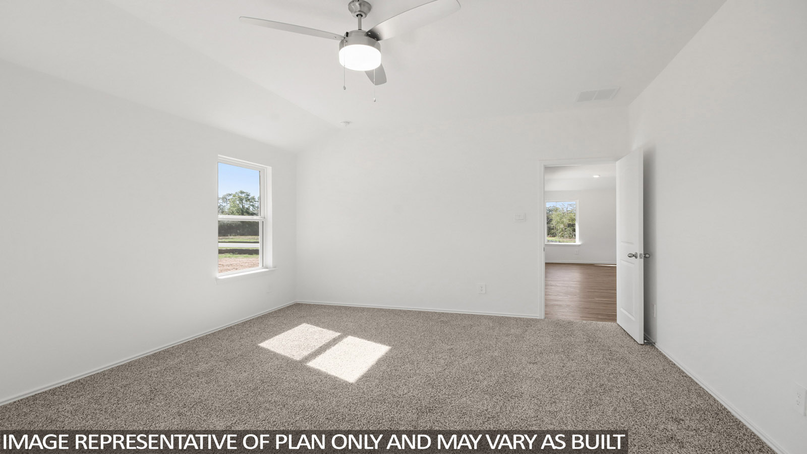 Primary bedroom with carpet flooring