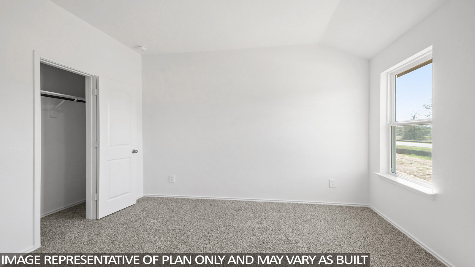 Secondary bedroom with carpet flooring