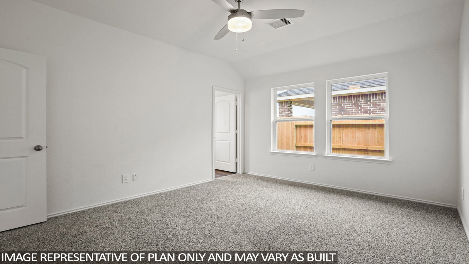Primary bedroom with carpet flooring, a ceiling fan, and bright windows.
