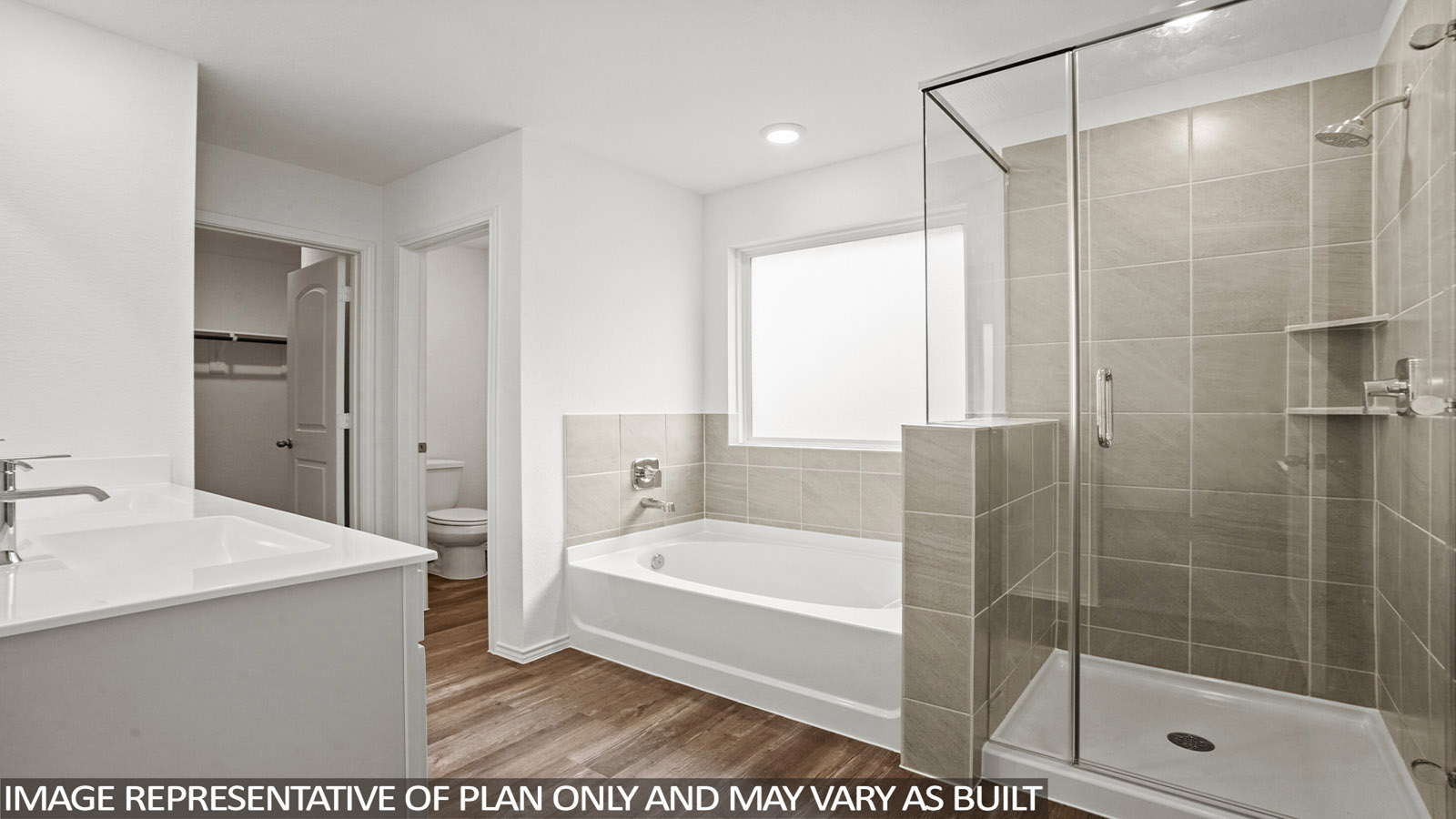 Primary bathroom with a separate toilet room and a walk-in closet.