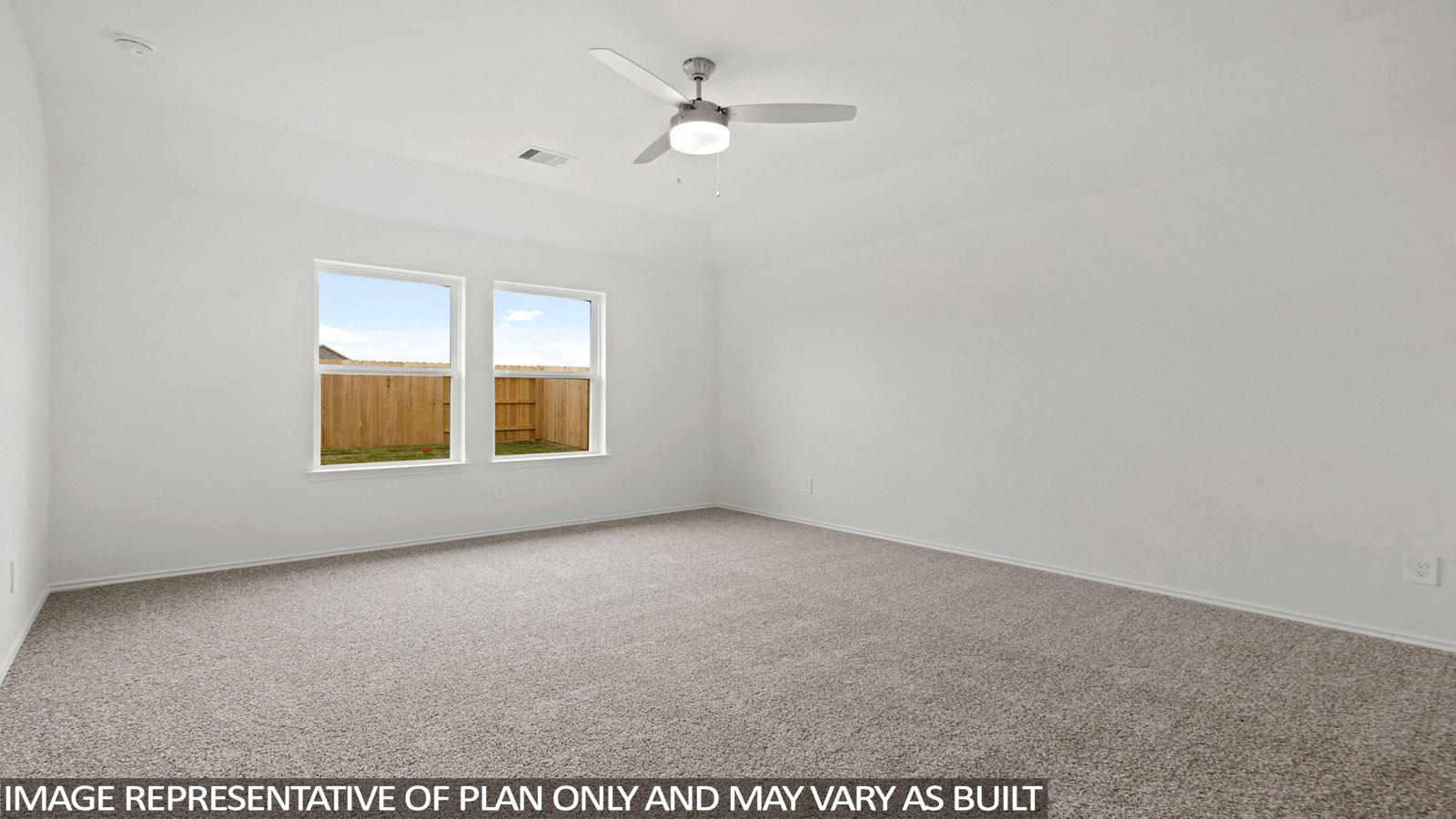 Primary bedroom with carpet flooring, a ceiling fan, and bright windows.