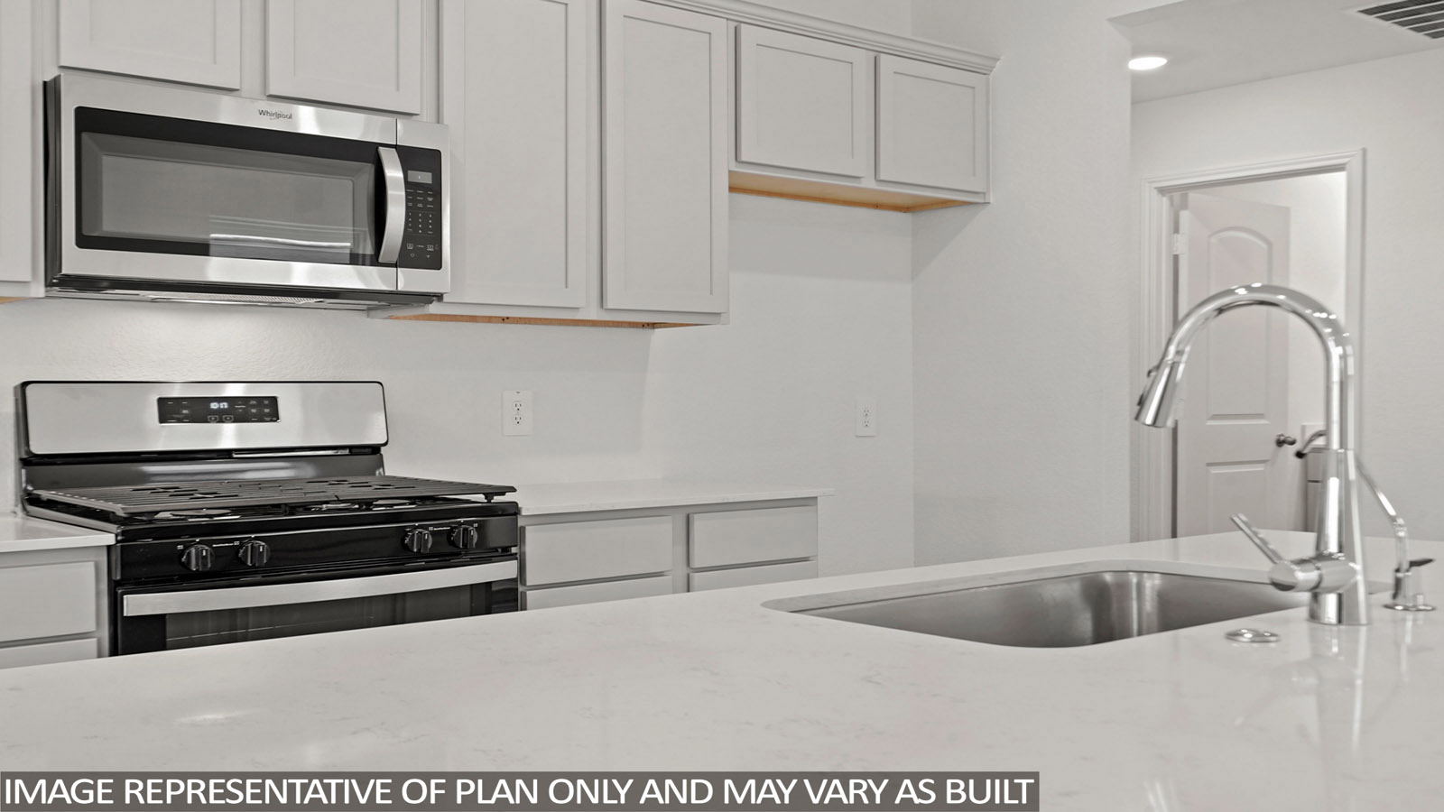 Kitchen with island and stainless-steel appliances.
