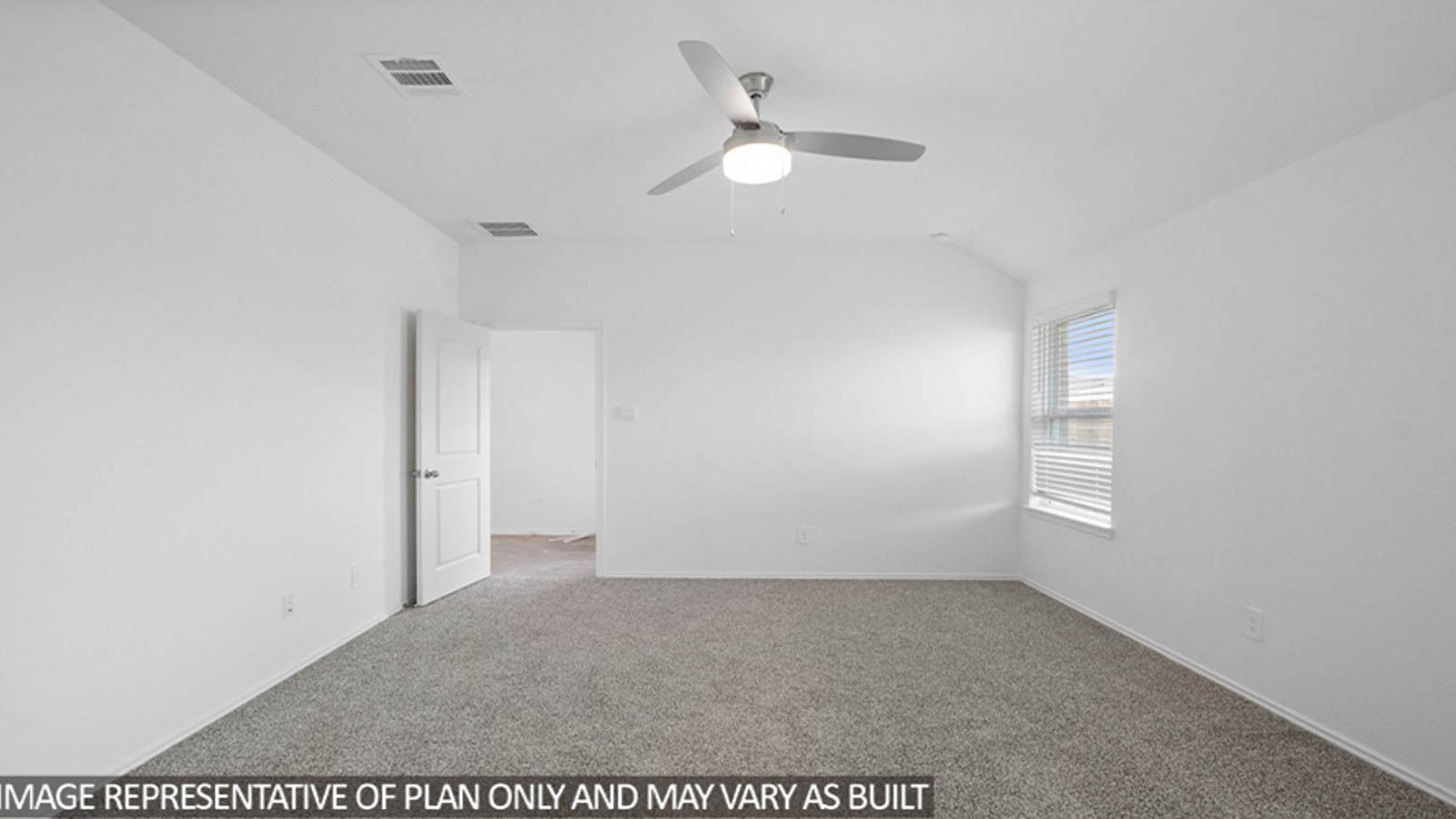 Primary bedroom with carpet flooring and bright windows.
