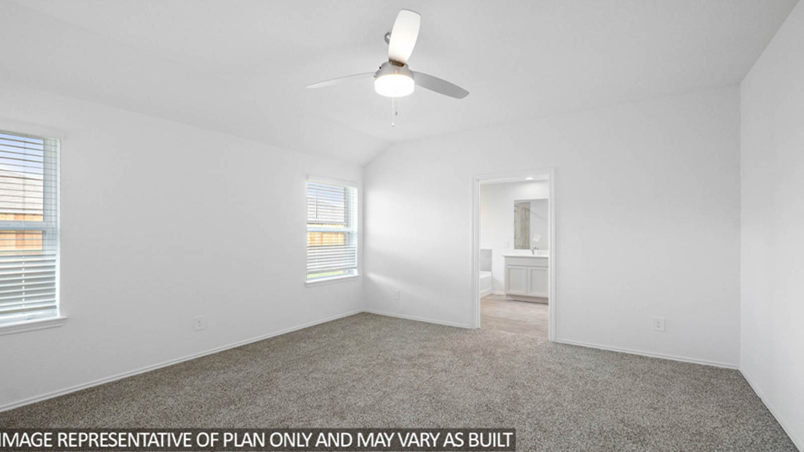 Primary bedroom with carpet flooring and bright windows.