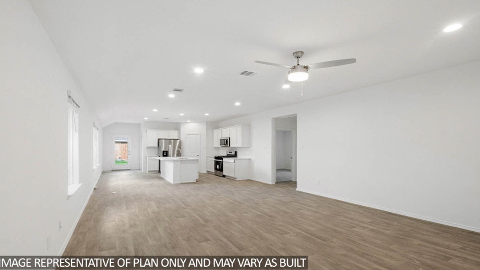 Open concept living and dining space with vinyl flooring.