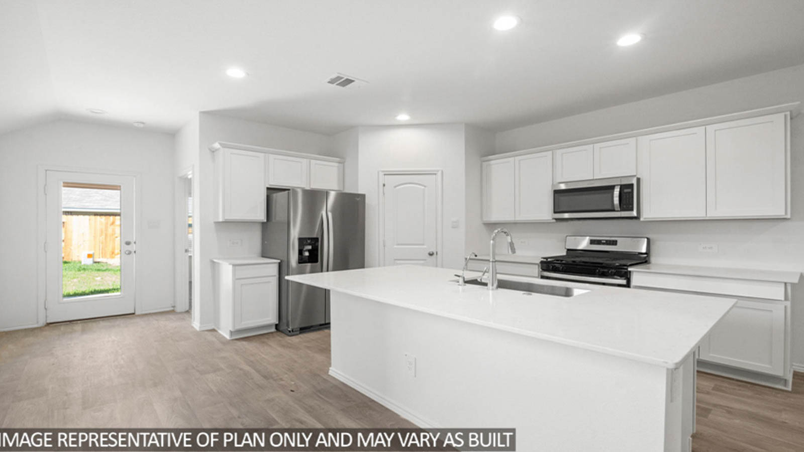 Kitchen with island and stainless-steel appliances.