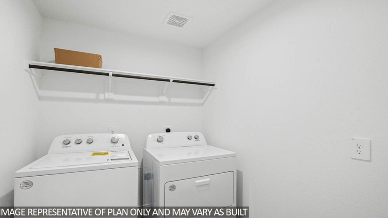 Utility room with vinyl flooring and overhead storage space.