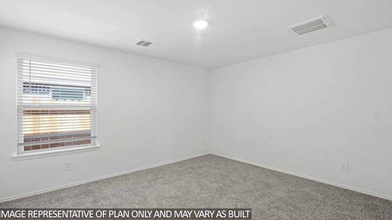Secondary bedroom with carpet flooring and a bright window.