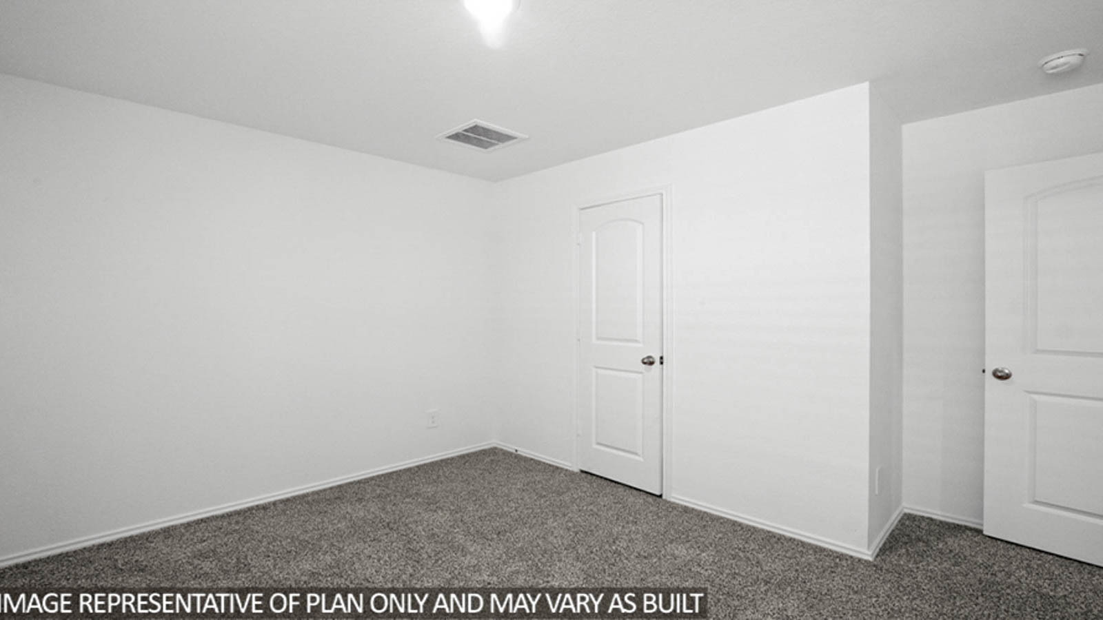 Secondary bedroom with carpet flooring and a tall closet.