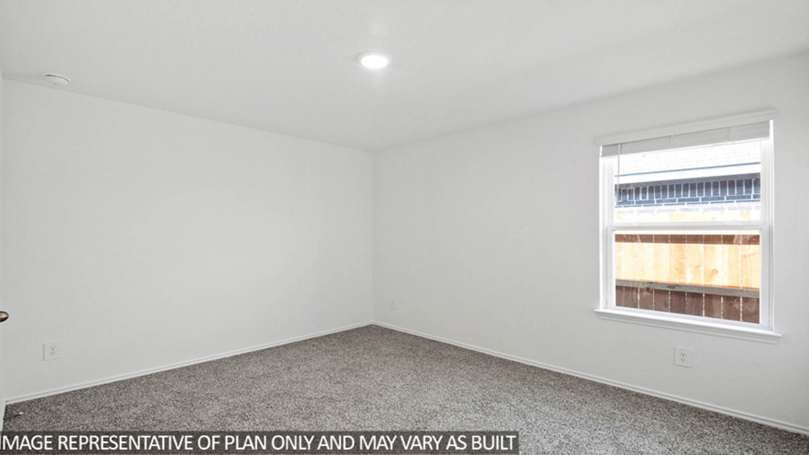 Secondary bedroom with carpet flooring and a bright window.