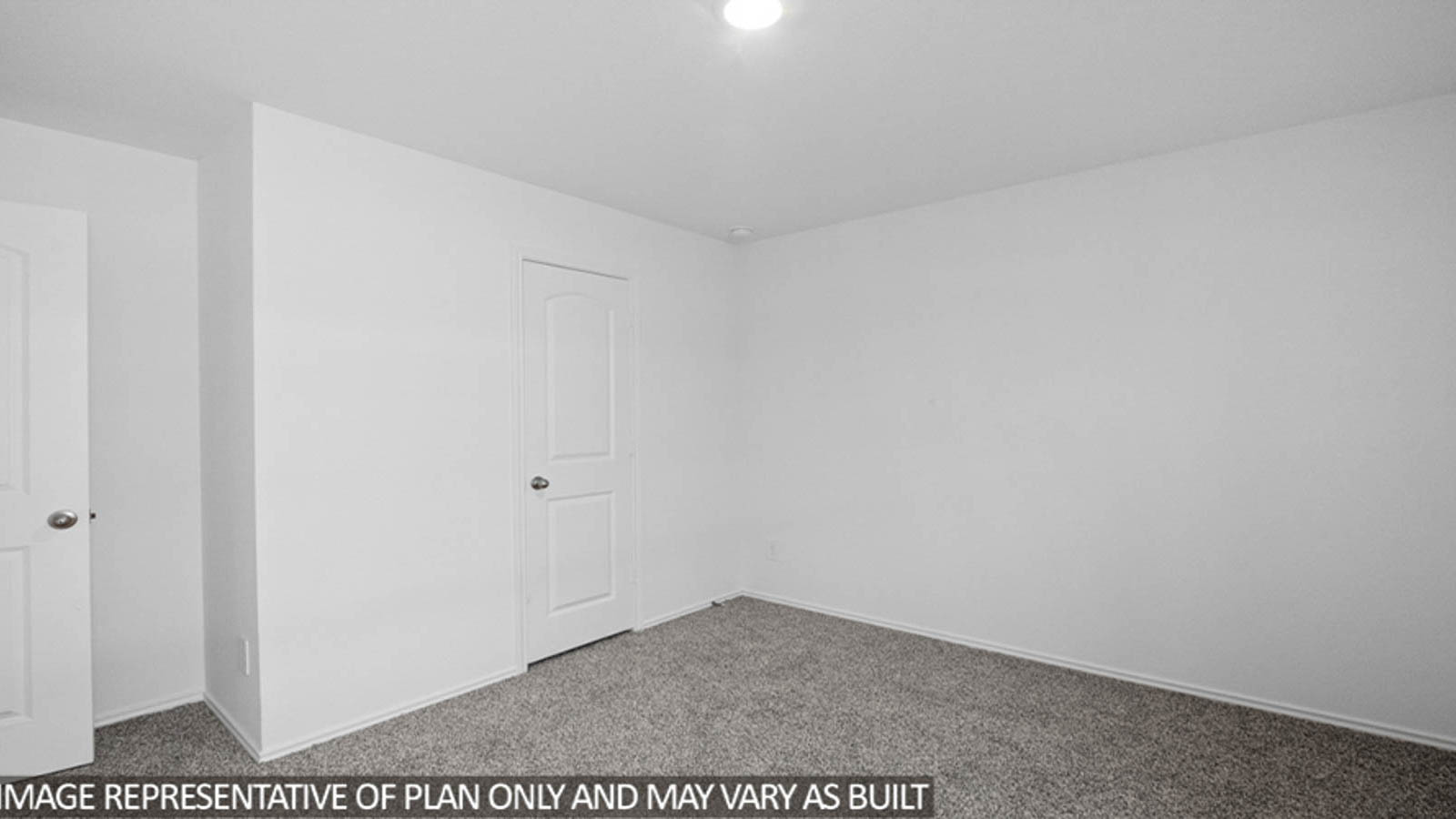 Secondary bedroom with carpet flooring and a tall closet.