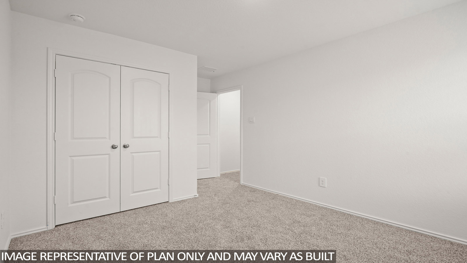 Secondary bedroom with carpet flooring and a tall closet.