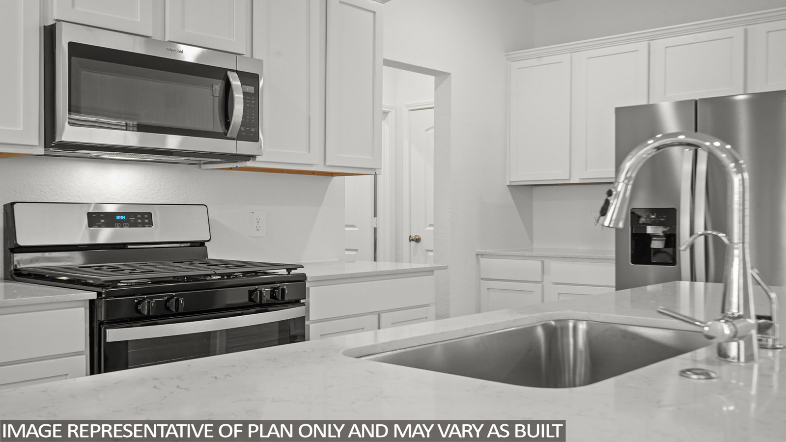 Kitchen with island and stainless-steel appliances.