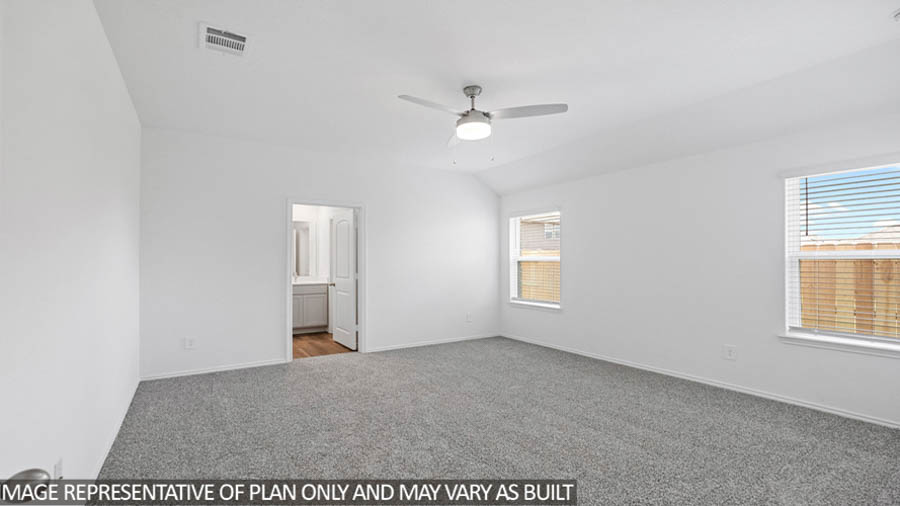 Primary bedroom with carpet flooring, a ceiling fan, and bright windows.