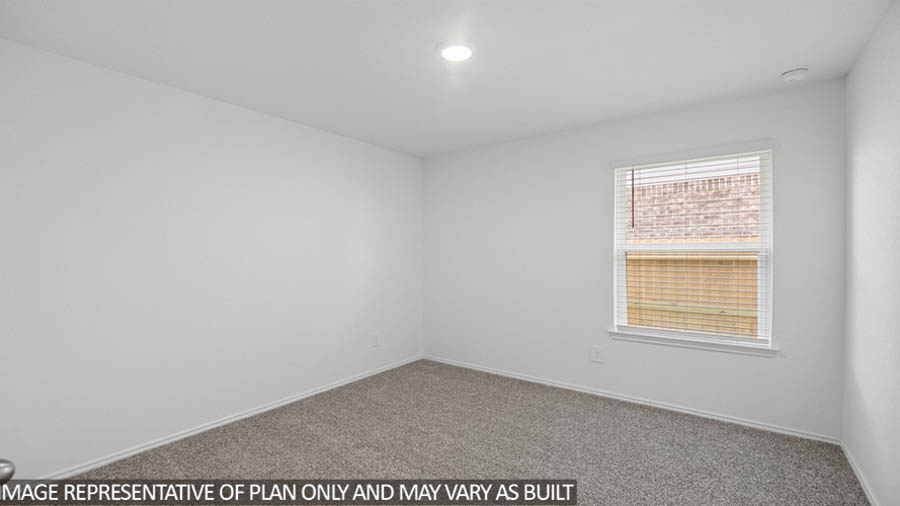 Secondary bedroom with carpet flooring and a bright window.