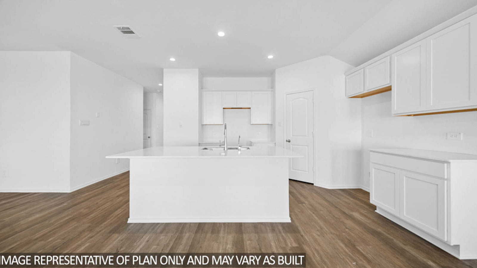 Kitchen with an island and a tall pantry.