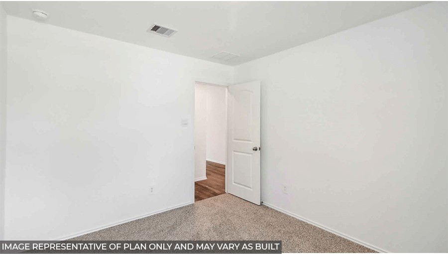 Secondary bedroom with carpet flooring