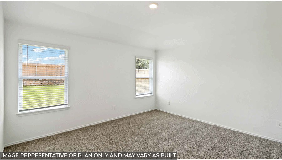 Primary bedroom with bright windows