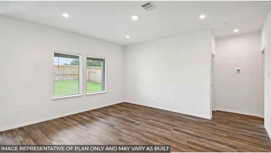 Spacious living area with vinyl flooring