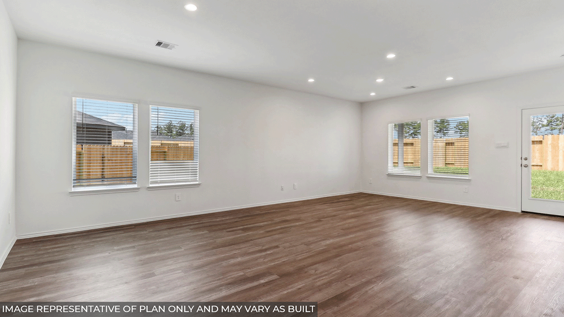 Spacious living area with vinyl flooring