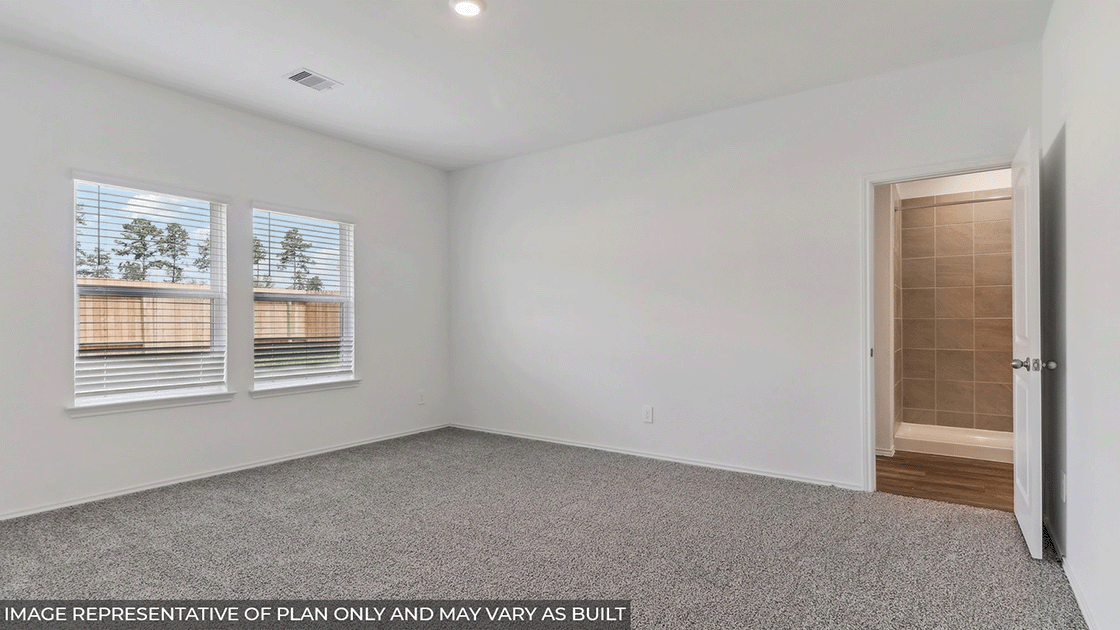 Primary bedroom with carpet flooring