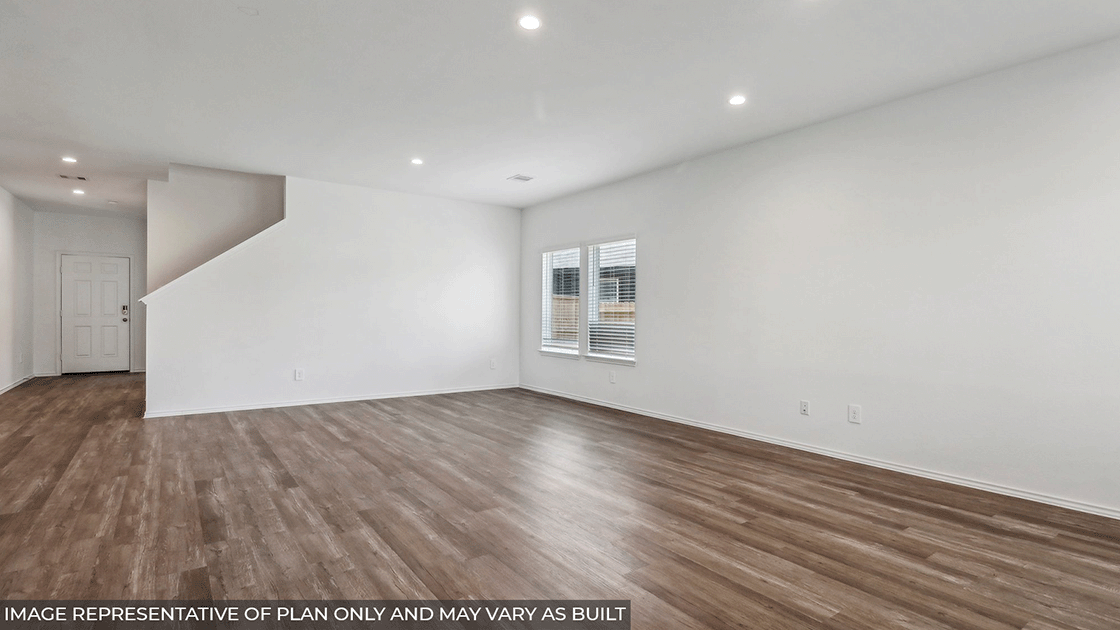 Spacious living area with vinyl flooring