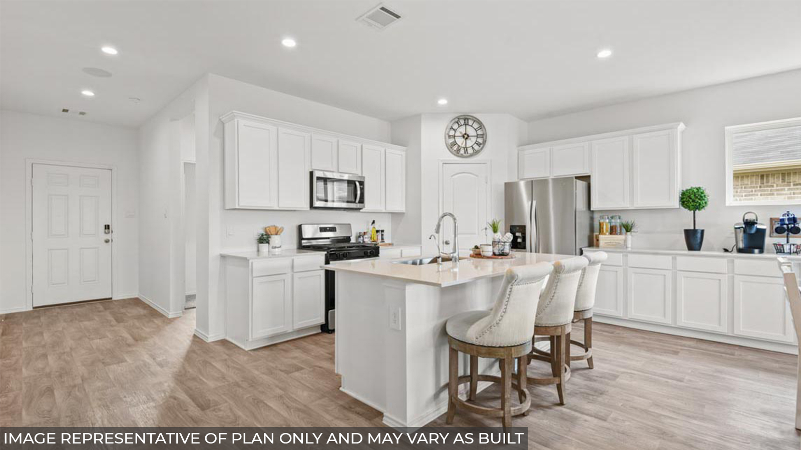 staged kitchen with stainless-steel appliances, a tall pantry, and extra countertop space