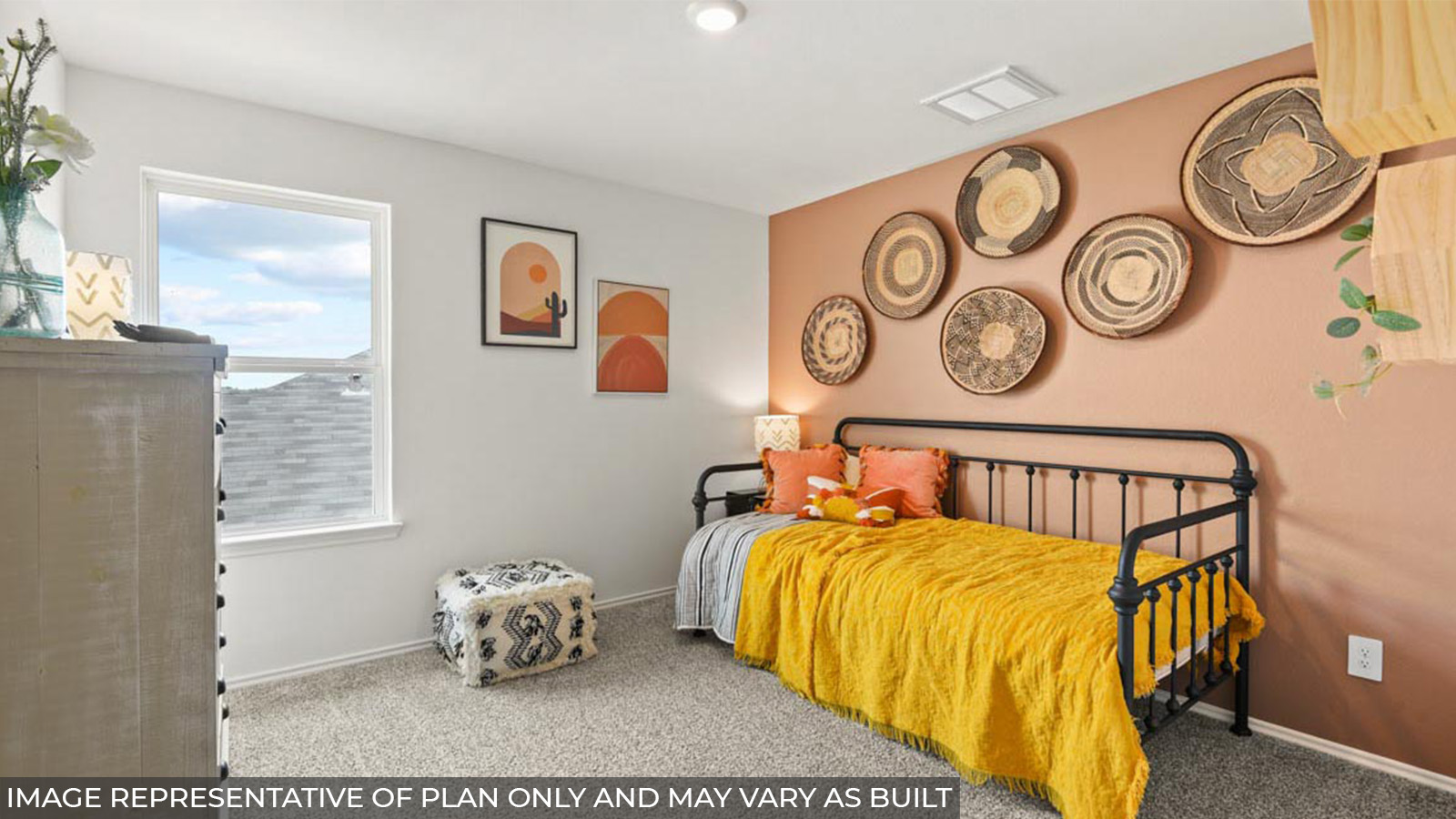 Staged secondary bedroom with carpet flooring and a bright window.