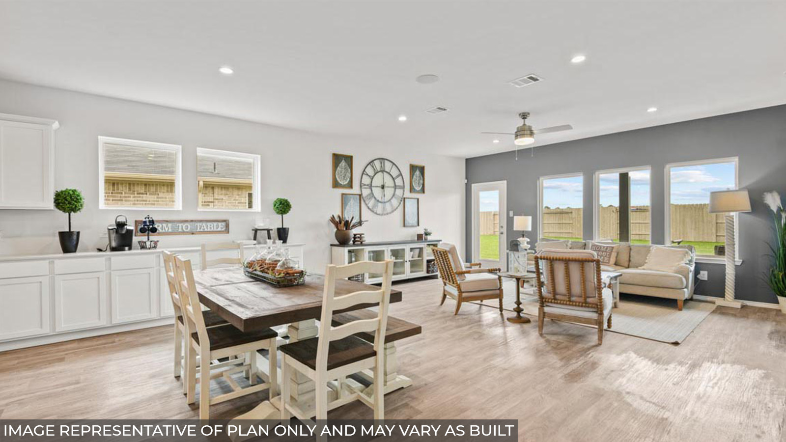 staged open concept living and dining room with vinyl flooring and bright windows