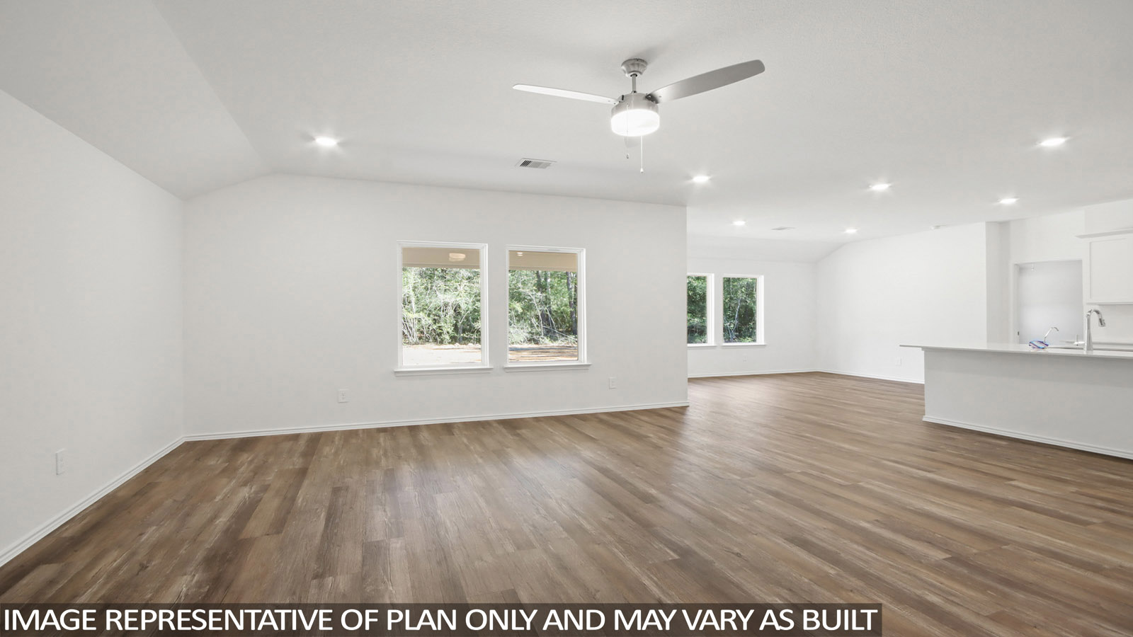 Spacious living area with vinyl flooring