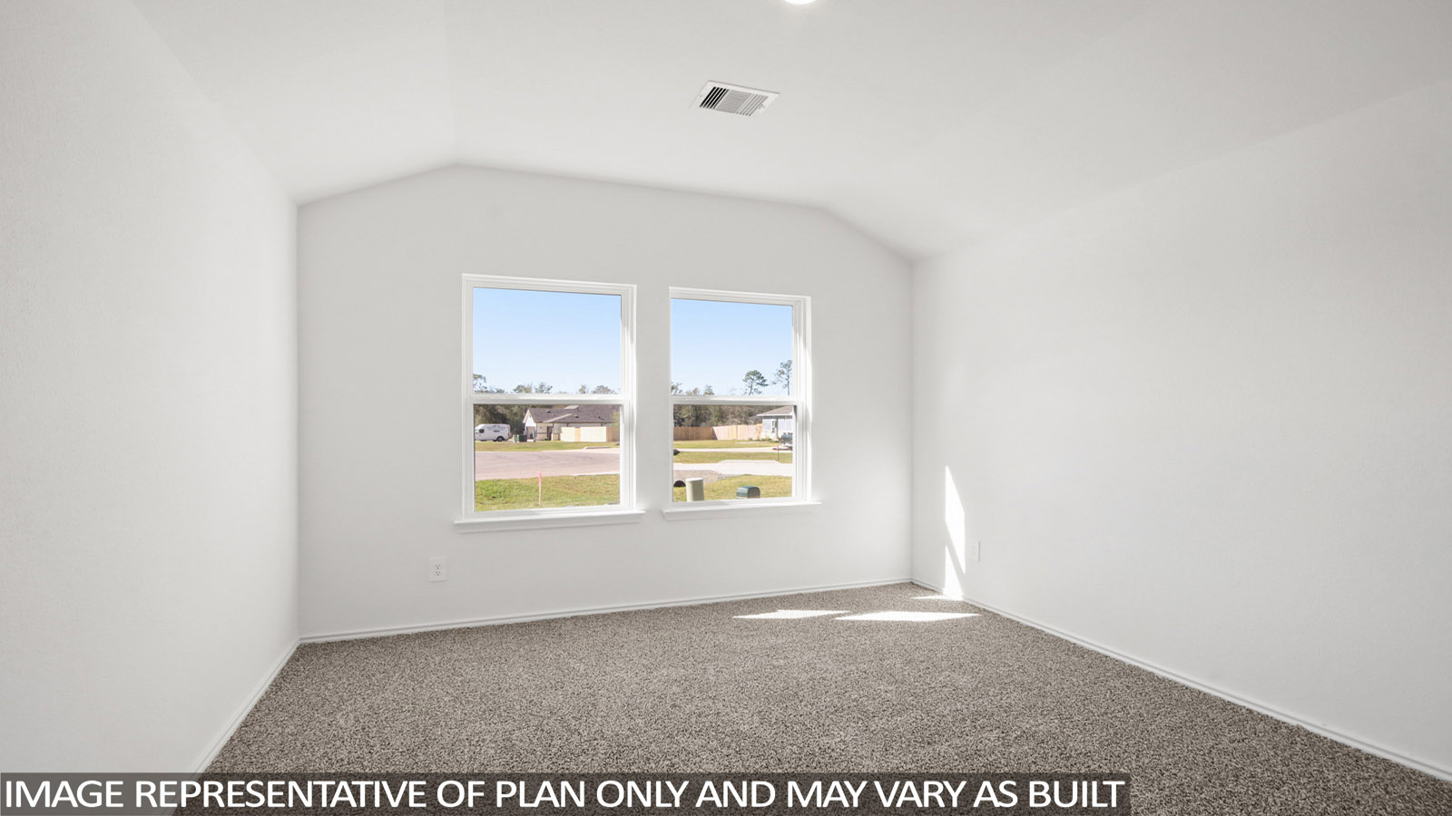 Secondary bedroom with carpet flooring