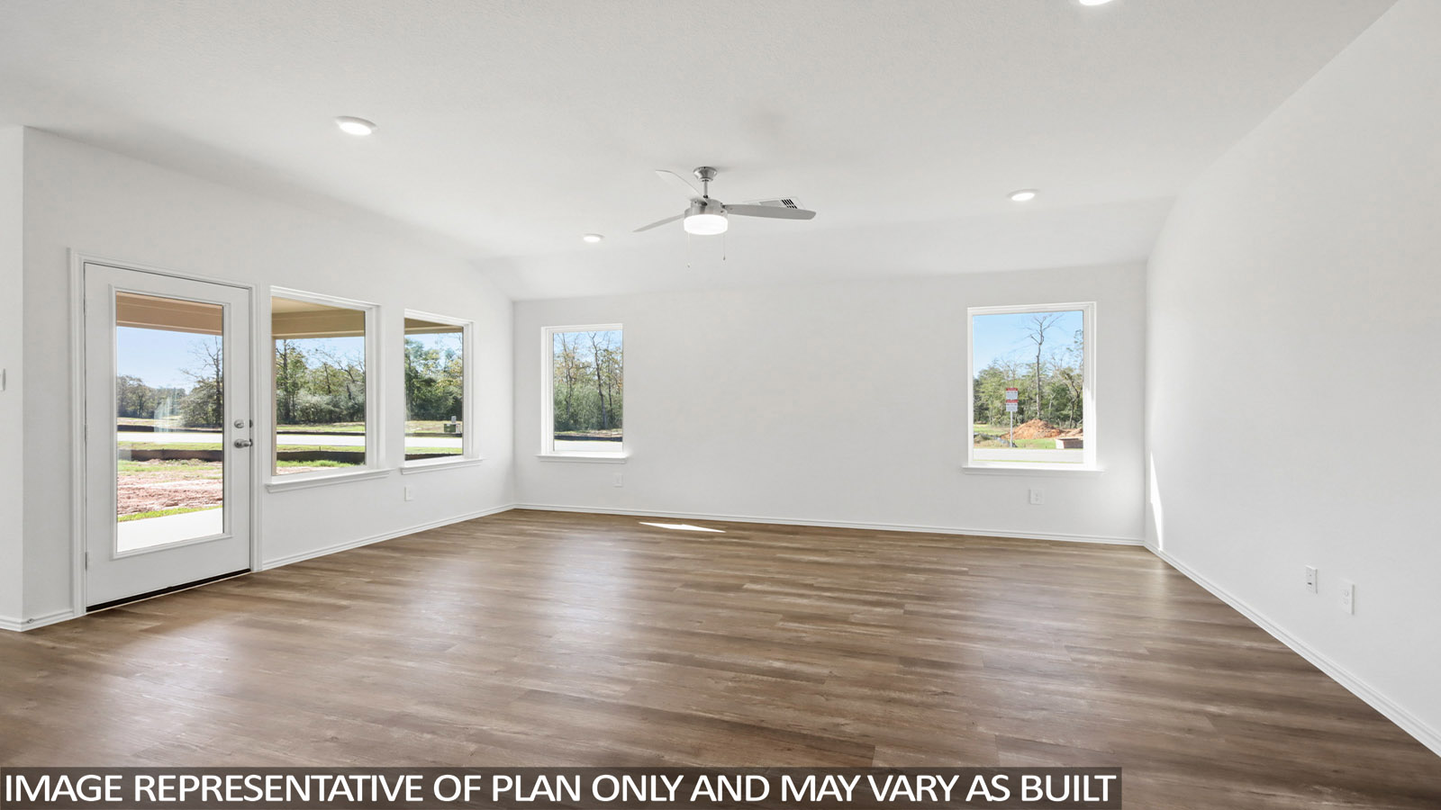Spacious living area with vinyl flooring