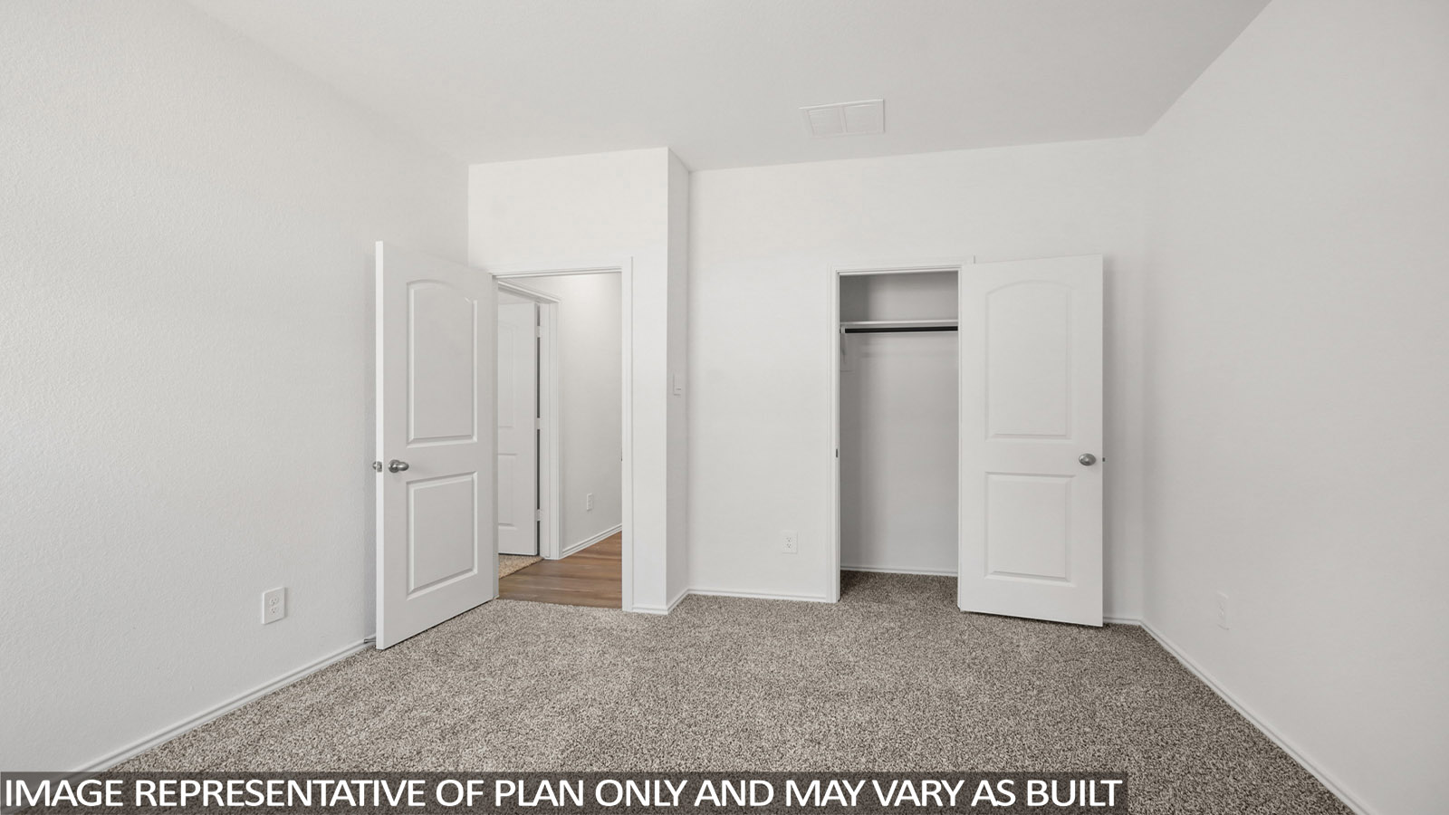 Secondary bedroom with carpet flooring