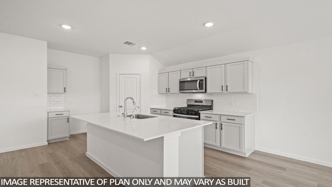 Kitchen with an island and vinyl floor