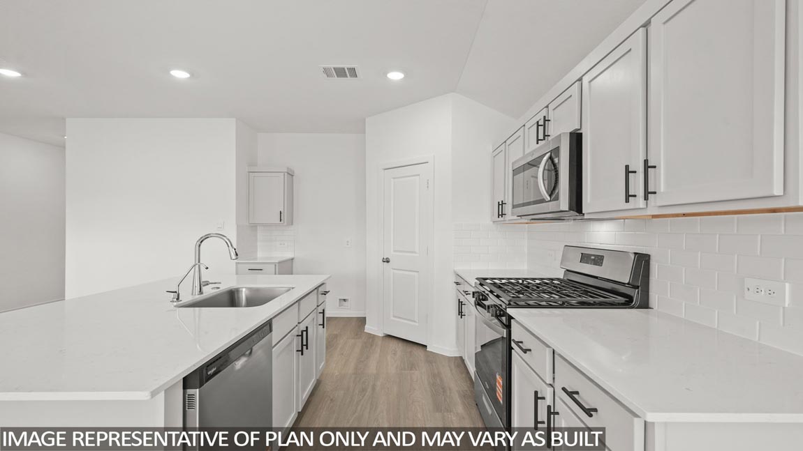 Kitchen with an island and vinyl floor
