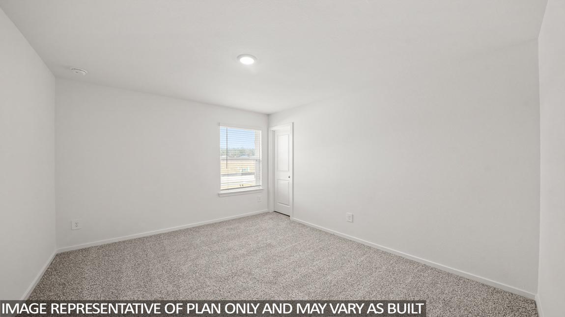 Secondary bedroom with carpet flooring