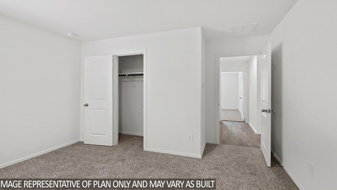 Secondary bedroom with carpet flooring