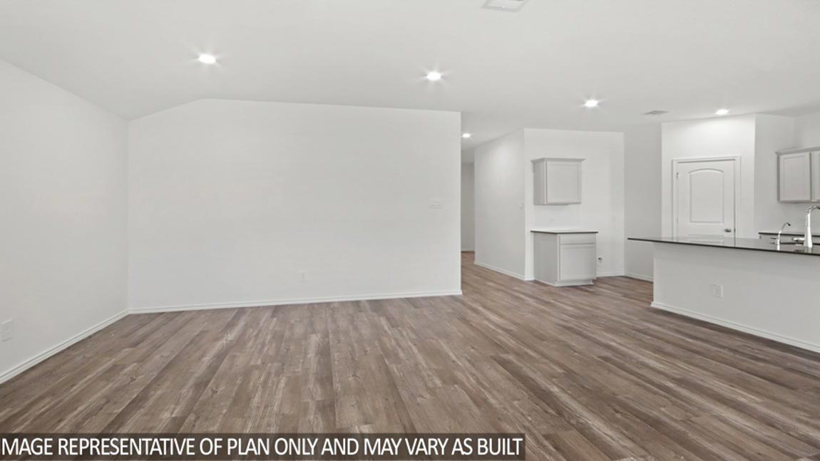 Spacious living area with vinyl flooring