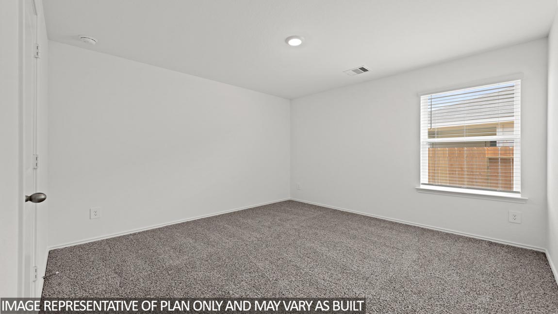 Secondary bedroom with carpet flooring