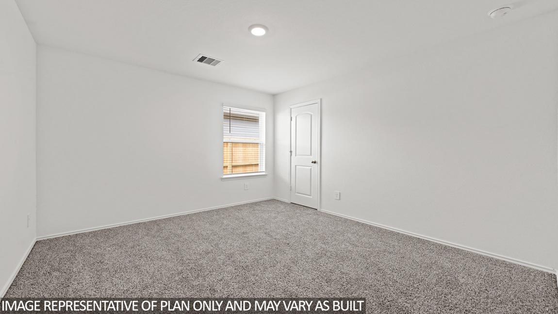 Secondary bedroom with carpet flooring