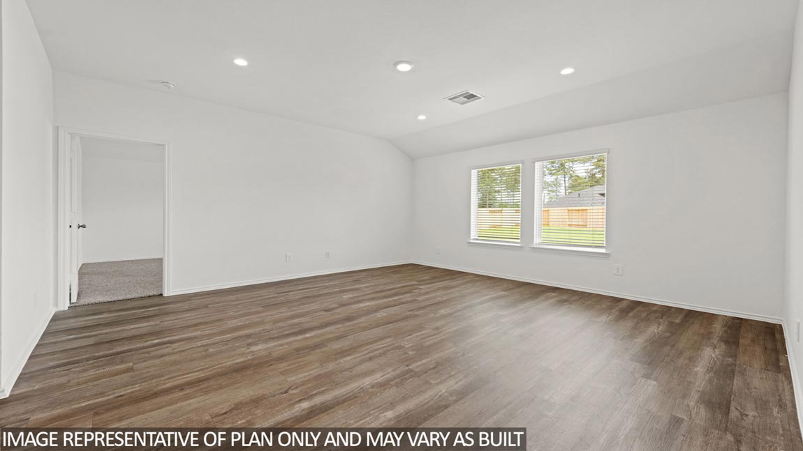Spacious living area with vinyl flooring