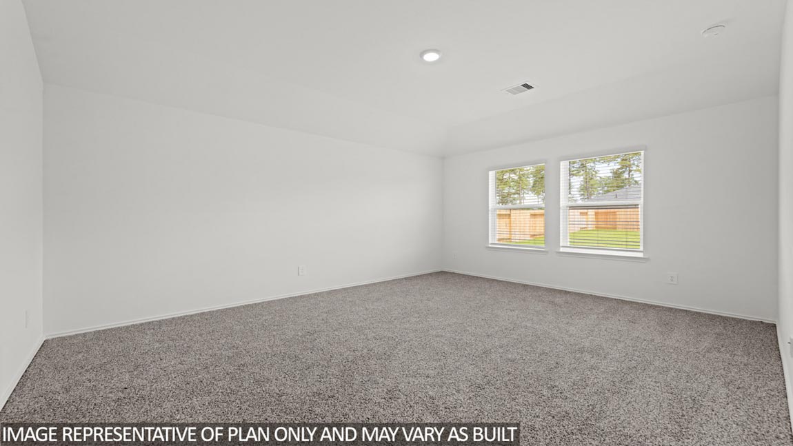 Primary bedroom with carpet flooring