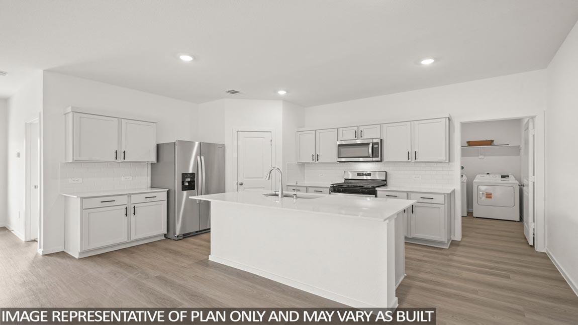 Kitchen with an island and vinyl floor