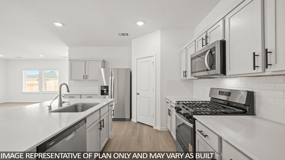 Kitchen with an island and vinyl floor