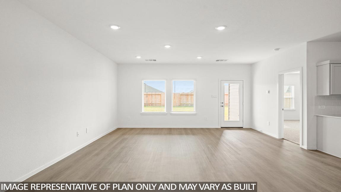 Spacious living area with vinyl flooring